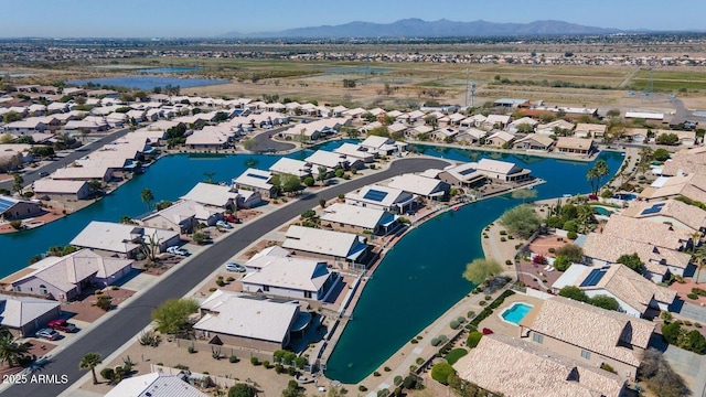 drone / aerial view featuring a water and mountain view