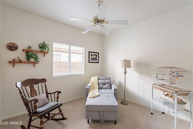 living area with light colored carpet and ceiling fan