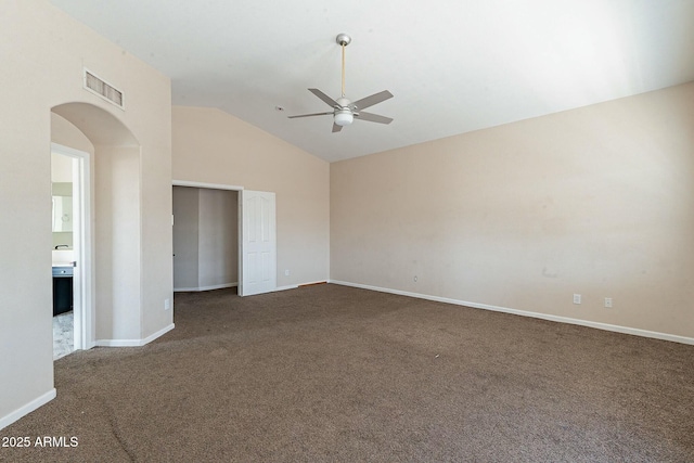 unfurnished room featuring visible vents, arched walkways, carpet flooring, and a ceiling fan