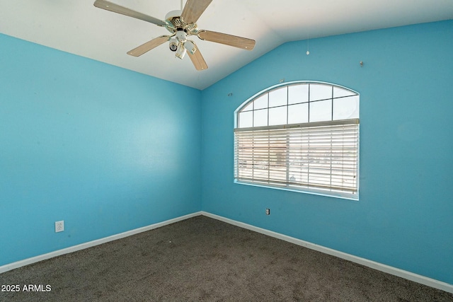 carpeted spare room with baseboards, vaulted ceiling, and a ceiling fan