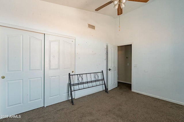 bedroom featuring a closet, high vaulted ceiling, visible vents, baseboards, and carpet floors