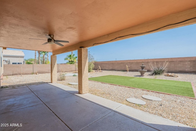 view of patio with a fenced backyard and a ceiling fan
