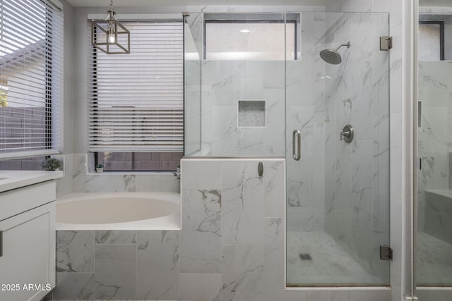 bathroom featuring vanity and shower with separate bathtub