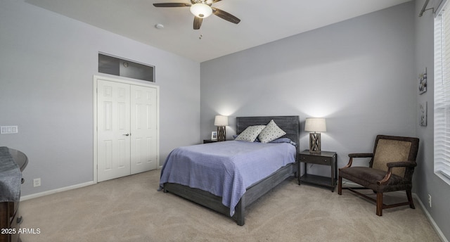 carpeted bedroom with ceiling fan and a closet