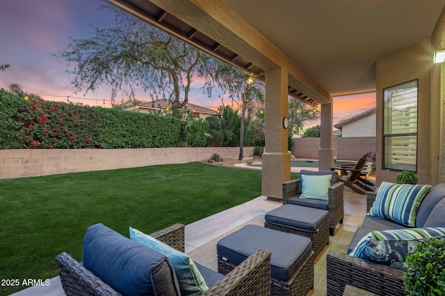 patio terrace at dusk featuring a yard and an outdoor hangout area
