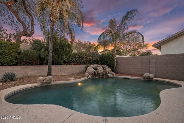 pool at dusk with pool water feature