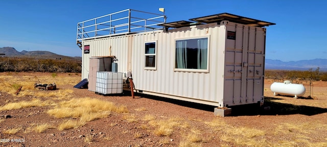 view of outbuilding with an outdoor structure and a mountain view