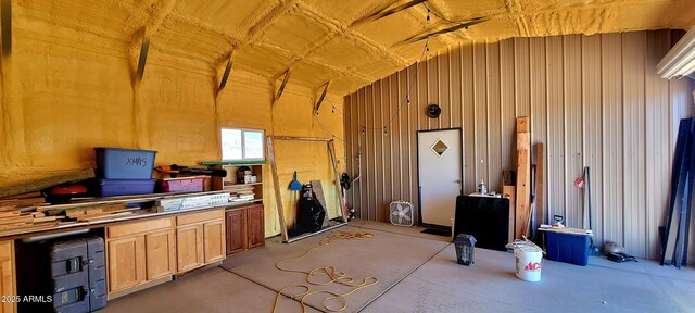 interior space featuring concrete floors and lofted ceiling