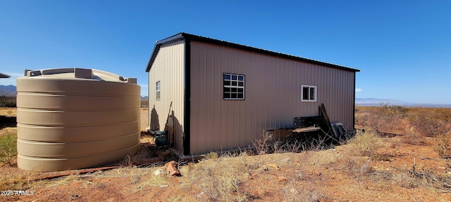 view of home's exterior with an outdoor structure