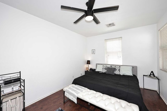 bedroom with dark hardwood / wood-style floors and ceiling fan