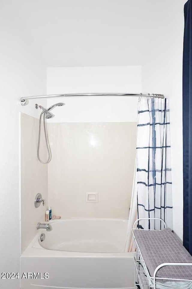 bathroom with shower / bath combination with curtain