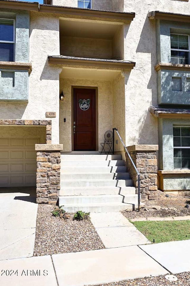 4306 E Tyson St, Gilbert, AZ 85295 - doorway to property with stucco siding and an attached garage