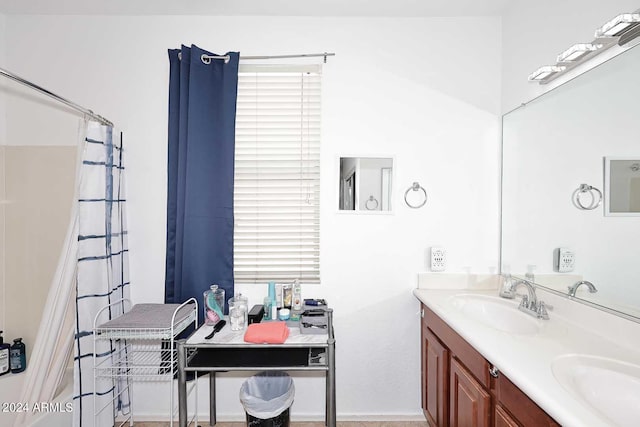 bathroom with walk in shower and vanity