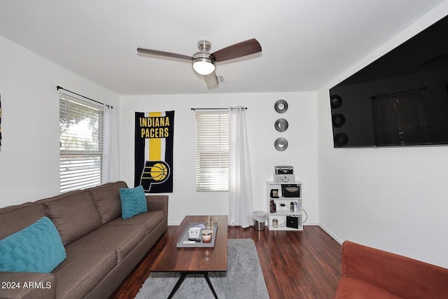 living room with ceiling fan and dark hardwood / wood-style flooring