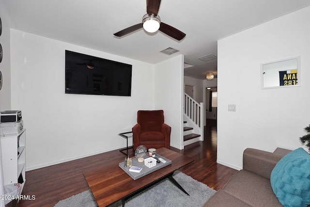 living room featuring ceiling fan and dark hardwood / wood-style flooring