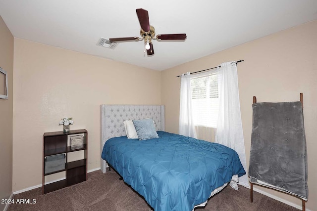 bedroom with ceiling fan and dark colored carpet