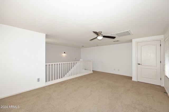 carpeted empty room featuring ceiling fan