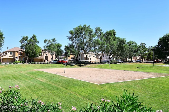 view of property's community featuring volleyball court and a yard