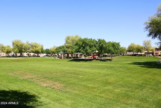 surrounding community with a playground and a yard