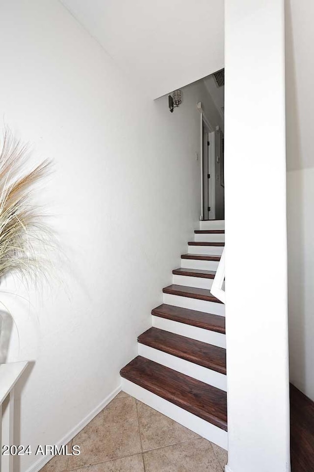 staircase with tile patterned floors