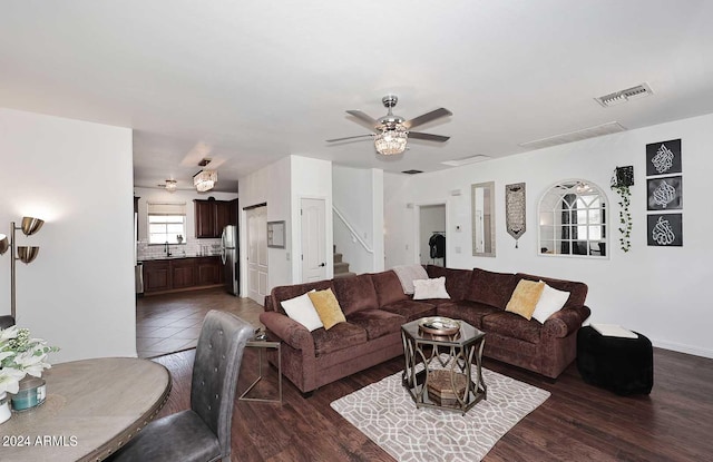 living room featuring ceiling fan and dark hardwood / wood-style flooring