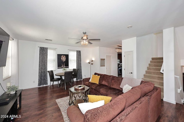 living room featuring ceiling fan and dark hardwood / wood-style floors