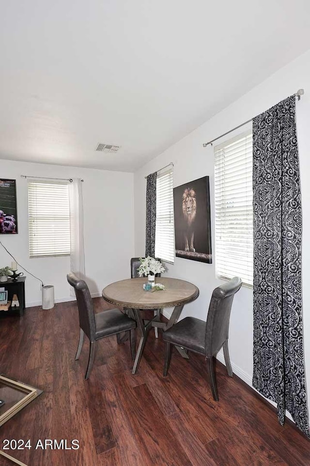 dining room with plenty of natural light and dark hardwood / wood-style floors