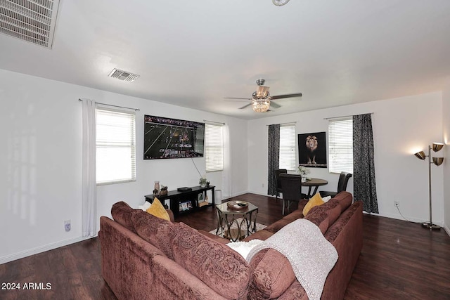 living room with ceiling fan and dark hardwood / wood-style flooring