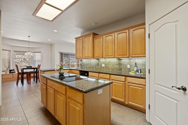 kitchen with black electric stovetop, backsplash, light tile patterned flooring, and a center island