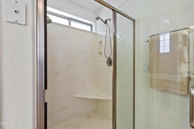 bathroom with a marble finish shower