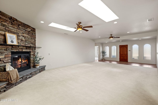 unfurnished living room with carpet flooring, recessed lighting, a fireplace, and visible vents