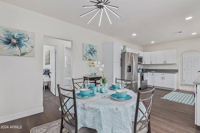 dining room with a notable chandelier and dark hardwood / wood-style floors