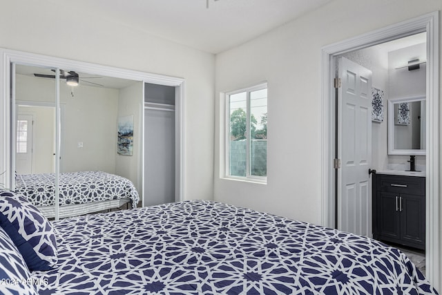 bedroom featuring connected bathroom, a closet, and ceiling fan