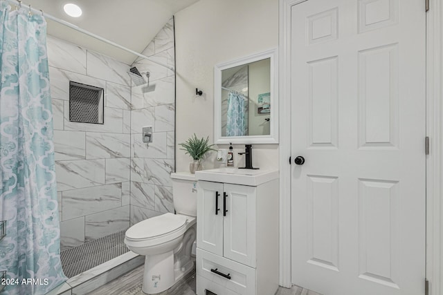 bathroom featuring a shower with curtain, vanity, and toilet