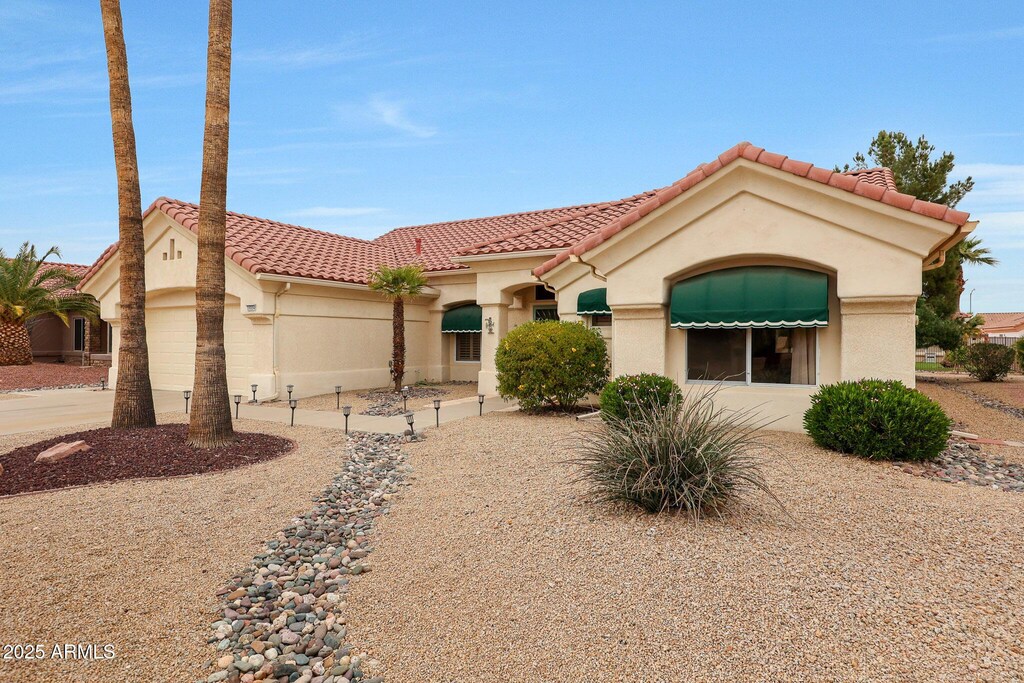 mediterranean / spanish-style home with a garage