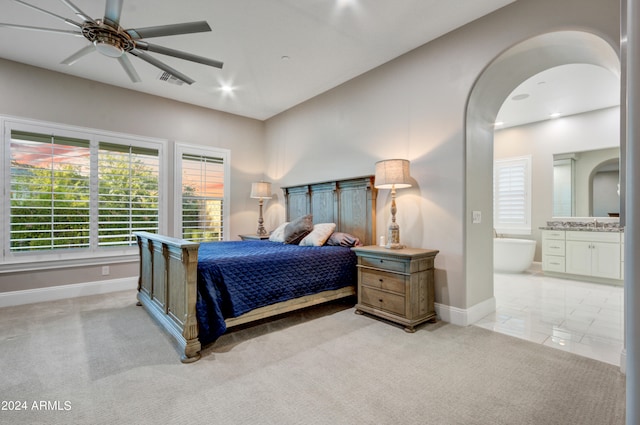 carpeted bedroom featuring connected bathroom and ceiling fan