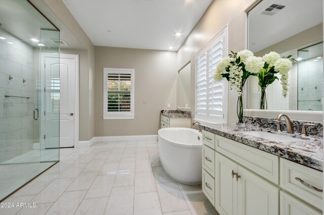 bathroom featuring independent shower and bath, tile patterned flooring, and vanity