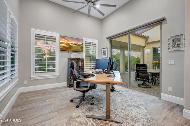 foyer with a towering ceiling and light hardwood / wood-style floors