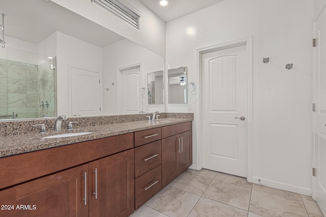 bathroom with vanity, a shower with door, and ceiling fan