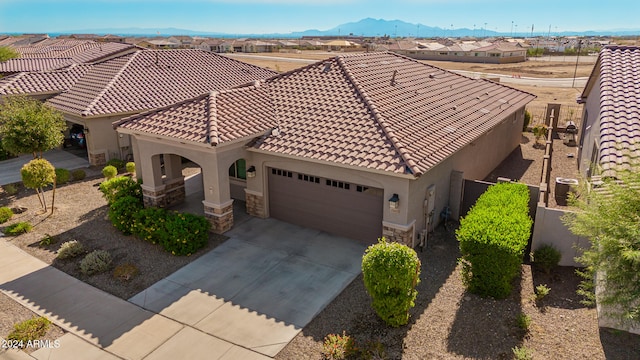 view of front of home featuring a mountain view and a garage