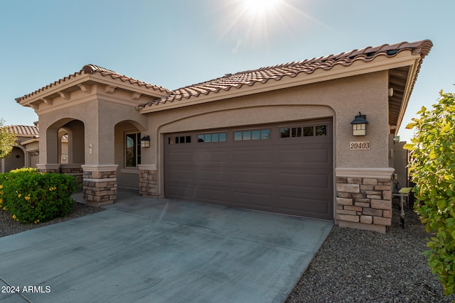 mediterranean / spanish house featuring a garage