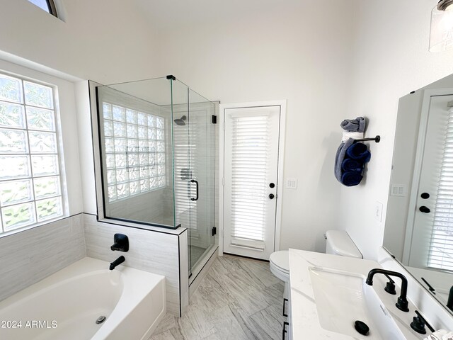 bathroom featuring vanity, toilet, and an enclosed shower