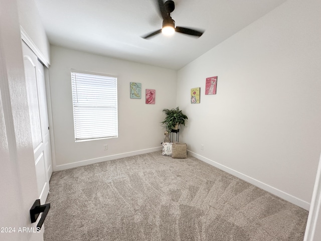 unfurnished bedroom with ceiling fan, light carpet, and vaulted ceiling