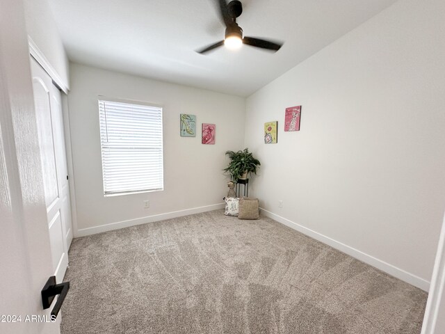 spare room with ceiling fan and carpet floors