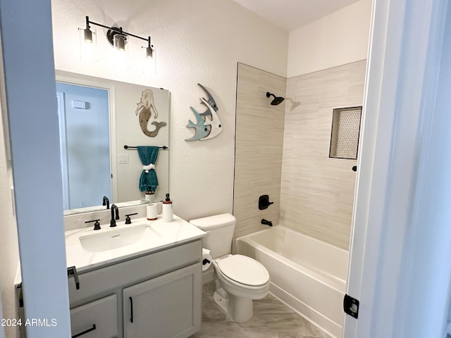 full bathroom featuring vanity, tiled shower / bath combo, and toilet