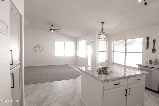 kitchen featuring vaulted ceiling, white cabinets, a kitchen island, dishwasher, and a healthy amount of sunlight