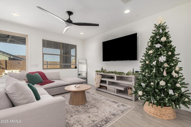 living room with ceiling fan and hardwood / wood-style floors