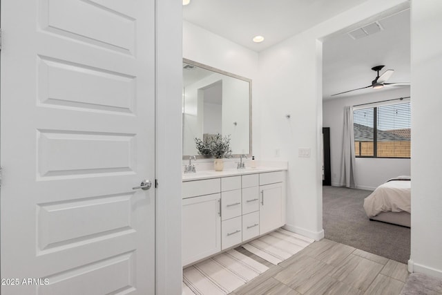 bathroom with ceiling fan and vanity