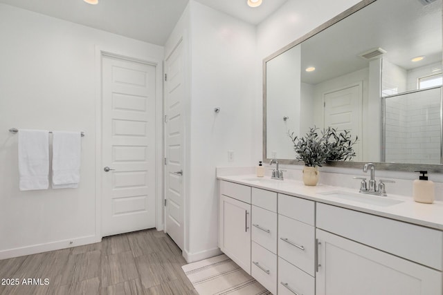 bathroom featuring vanity and a shower with shower door