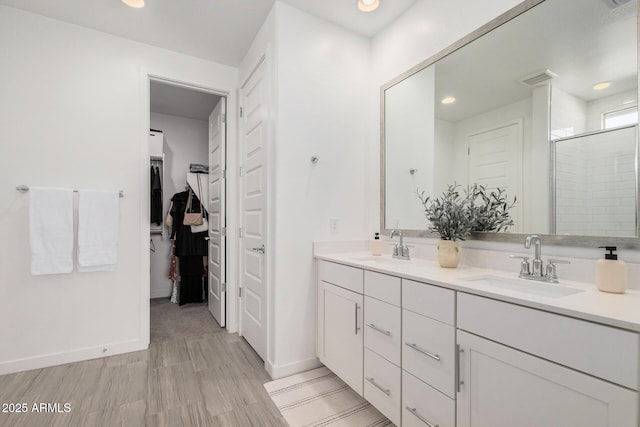 bathroom featuring vanity and an enclosed shower